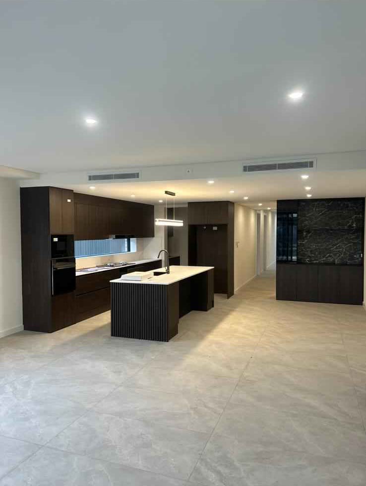 Dark timber kitchen with a large island bench